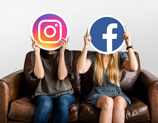 The women hold the icons of social media
